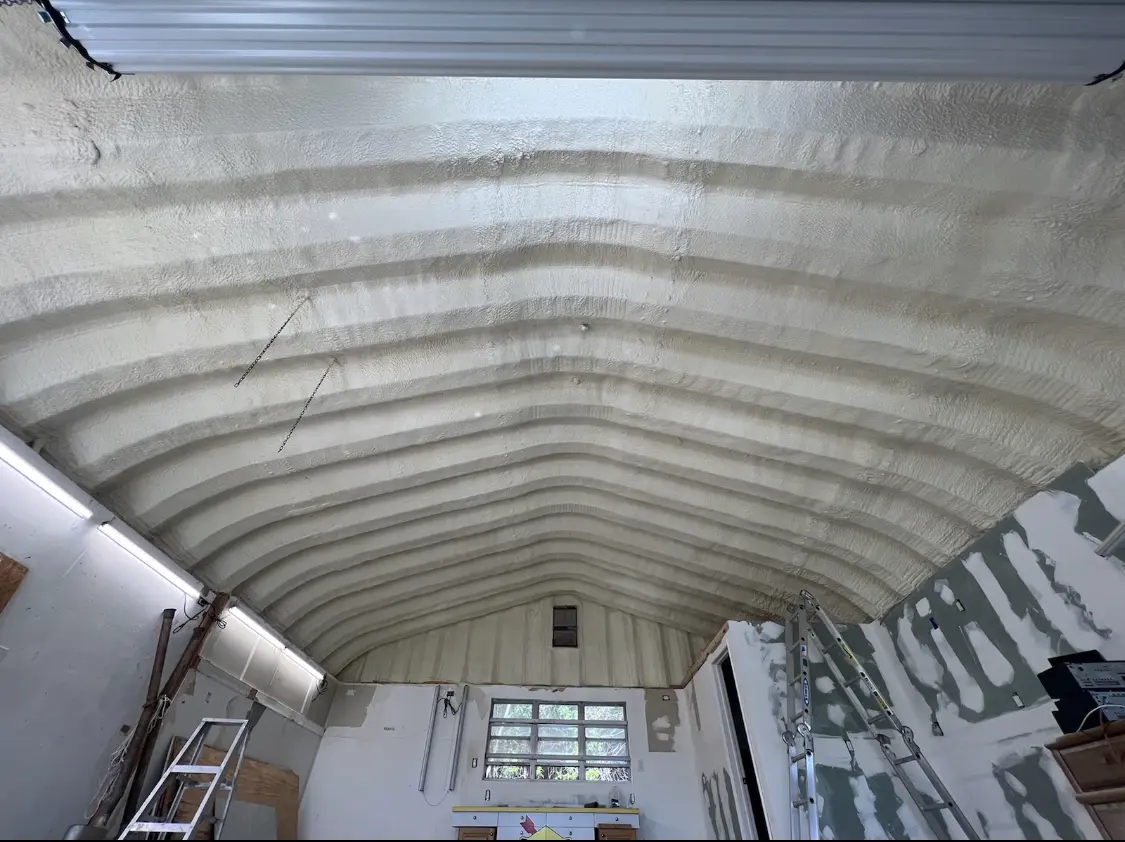 Spray polyurethane foam applied to the underside of a metal roof deck in Lamont